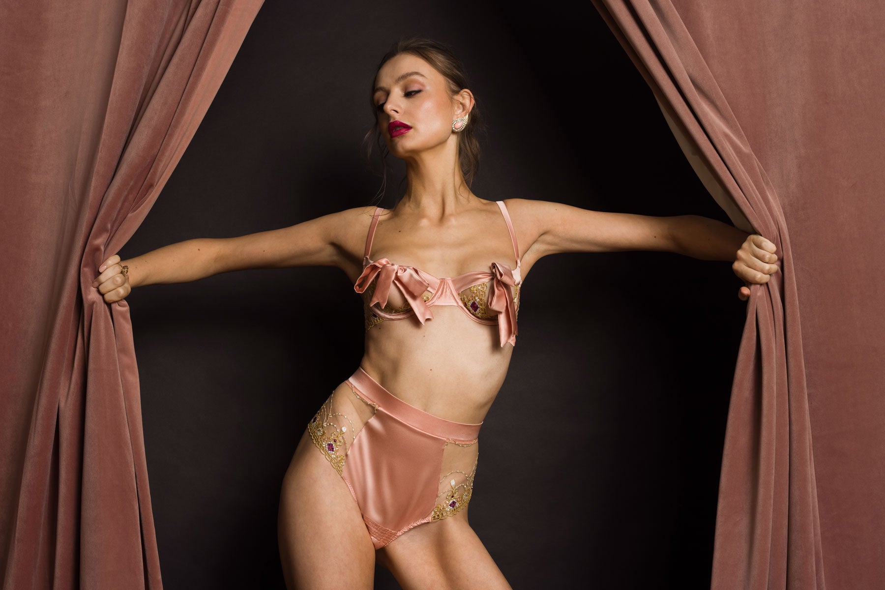 Studio Pia Balconette bra with silk bow cup detail in coral peach ethical silk with matching high waisted thong - front on model